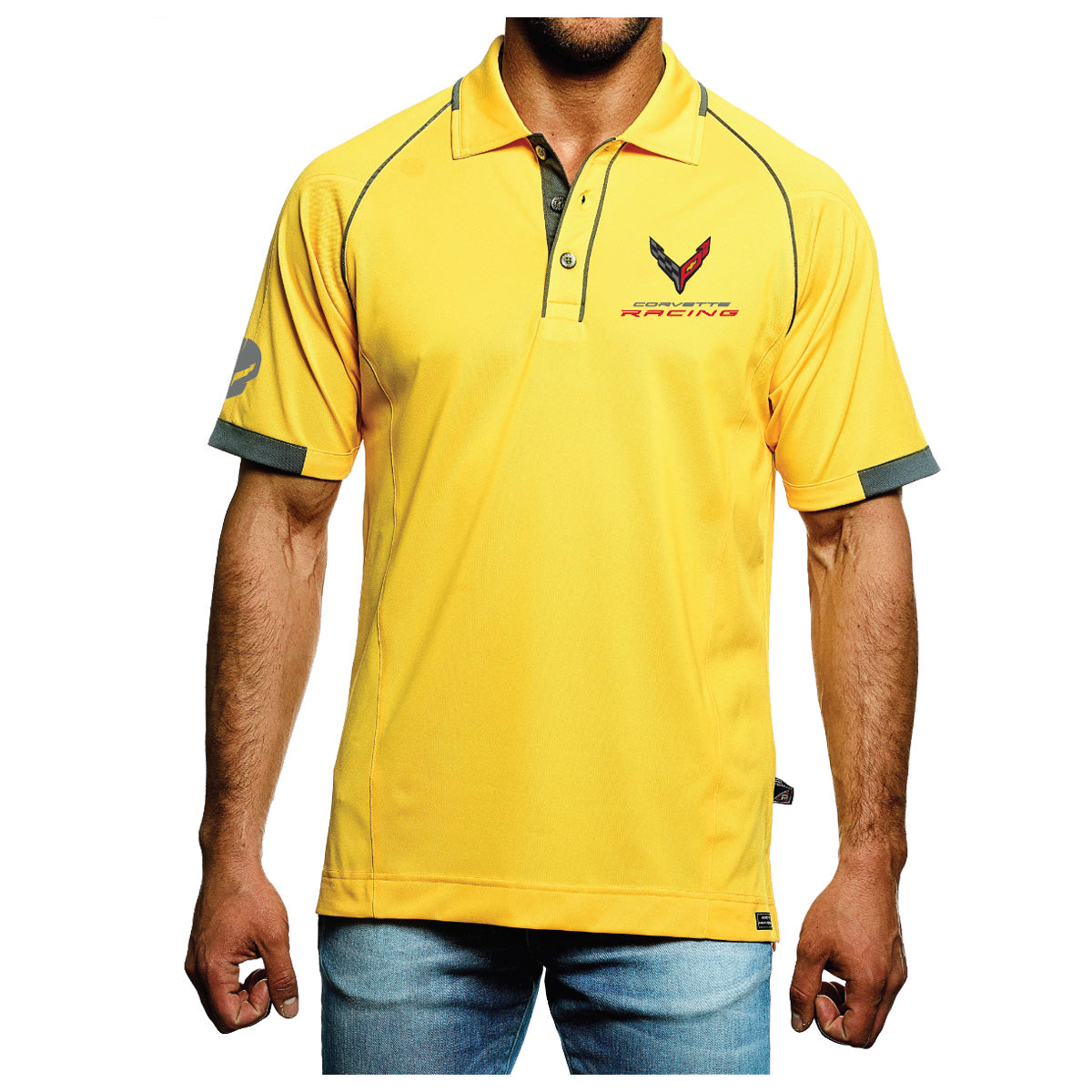 Corvette Racing "JAKE" Polo - Yellow/Gray - A man wearing a bright yellow short-sleeve polo shirt with dark gray trim on the collar, placket, and sleeve cuffs, paired with blue jeans against a plain white background.