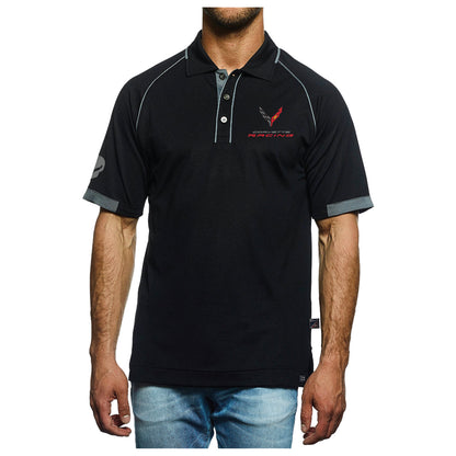 A man wearing a black short-sleeve polo shirt with gray piping, a gray collar and sleeve trim, and a red and black logo on the left chest. He is also wearing blue jeans, shown from the chin down against a plain white background.